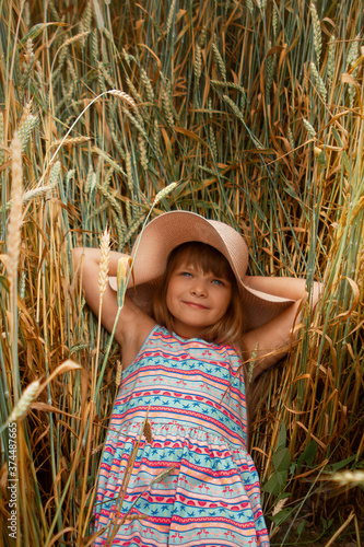 Girl in a hat in a whead field photo