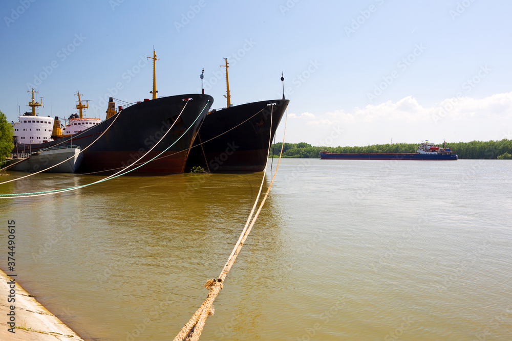 Barges on dock of river port on Danube River, shipping.