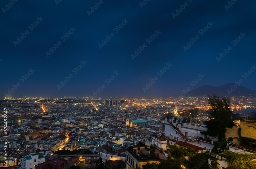 Fototapeta premium View of Naples at night and Vesuvius volcano in the background