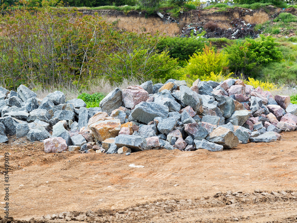 Gravel, granite stones, bout on the open construction site. Preparation for the construction of a new highway.
