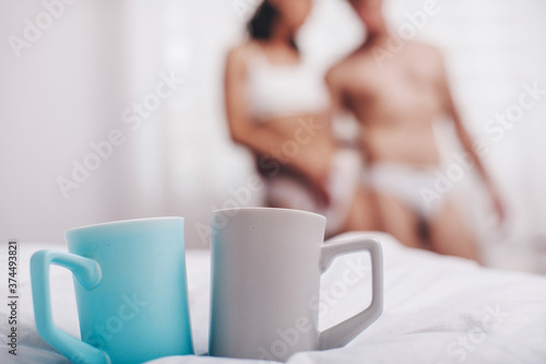 Breakfast in bed in hotel room. Breakfast in bed with tea cup. Couple love. Sensual. Good morning. 