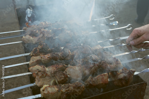 Wallpaper Mural Grilled kebab cooking on metal skewer. Roasted meat cooked at barbecue. BBQ fresh beef meat chop slices. Traditional eastern dish, shish kebab. Grill on charcoal and flame, picnic, street food Torontodigital.ca