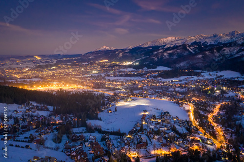 Obraz na płótnie Blue and orange Zakopane in winter at night, aerial view w salonie