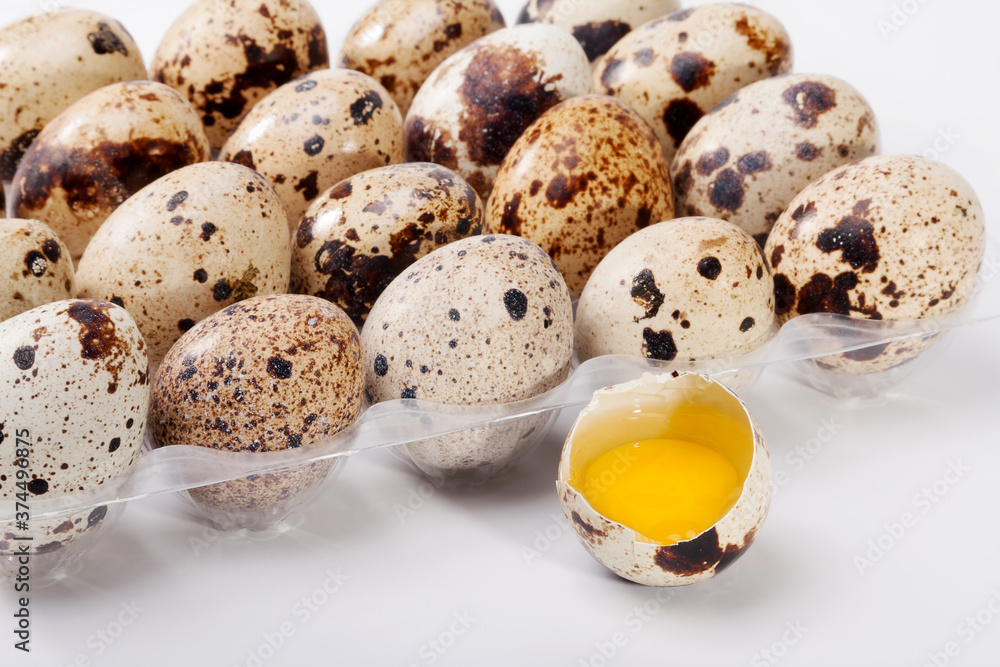 Eggs quail, broken egg in plastic container Eggs quail, broken egg in plastic container