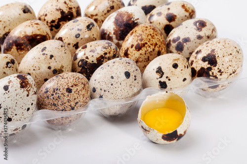 Eggs quail, broken egg in plastic container