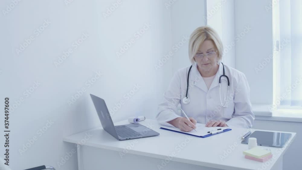 Clinic specialist writing report, working in office, filling medical history Clinic specialist writing report, working in office, filling medical history