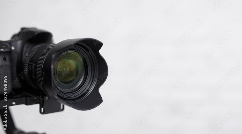 close up of modern dslr camera over white background with copy space