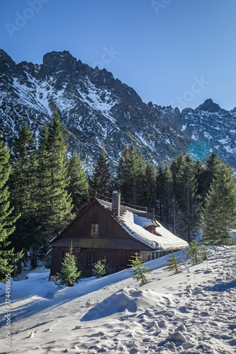 Fototapeta Naklejka Na Ścianę i Meble -  Wooden mountain shelter by sea eye lake in winter, Tatras