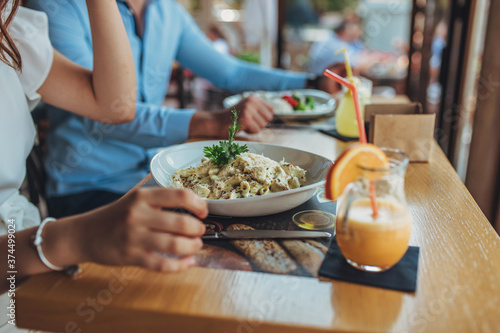 A combination of food and cocktails.Pasta and pork.