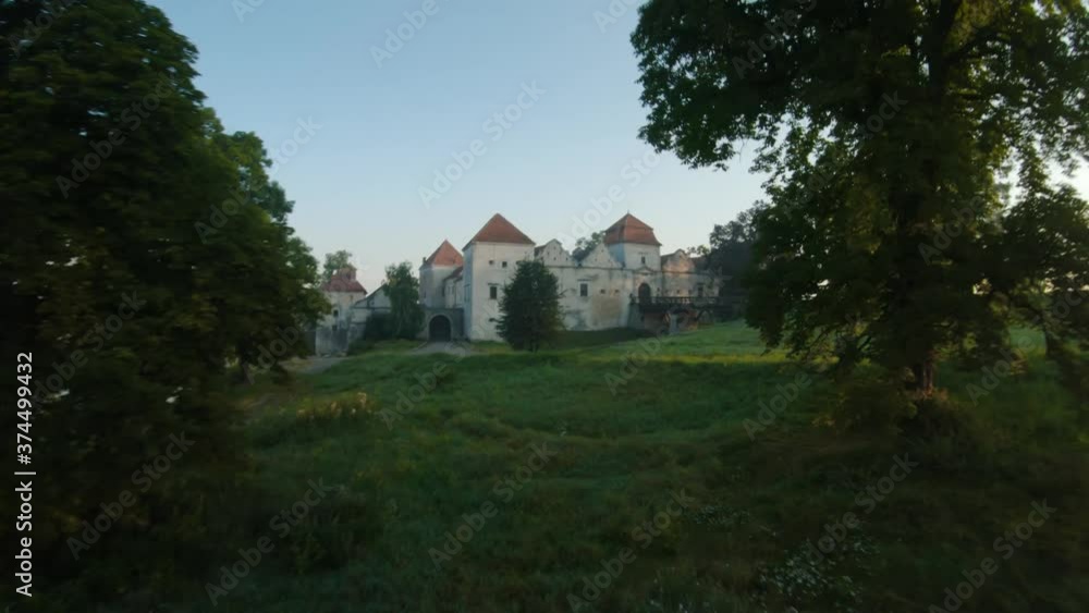 Colorful hot air balloons fly over the medieval castle and lake in the morning fog. Maneuverable flight and power loops. Travel, adventure, festival. Colorful hot air balloons fly over the medieval castle and lake in the morning fog. Maneuverable flight and power loops. Travel, adventure, festival.