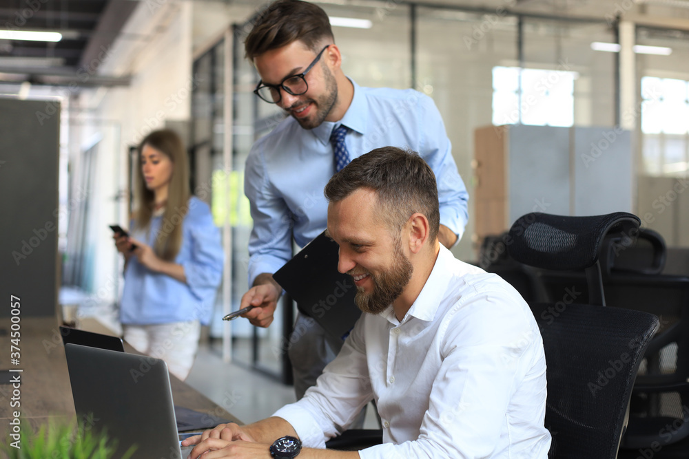 Group of young modern people discussing business in the office. Group of young modern people discussing business in the office.
