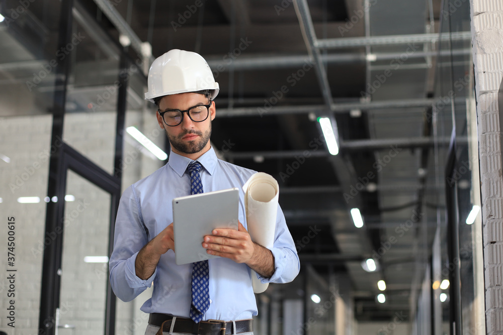 Shot of a engineer using a digital tablet on a construction site. Shot of a engineer using a digital tablet on a construction site.