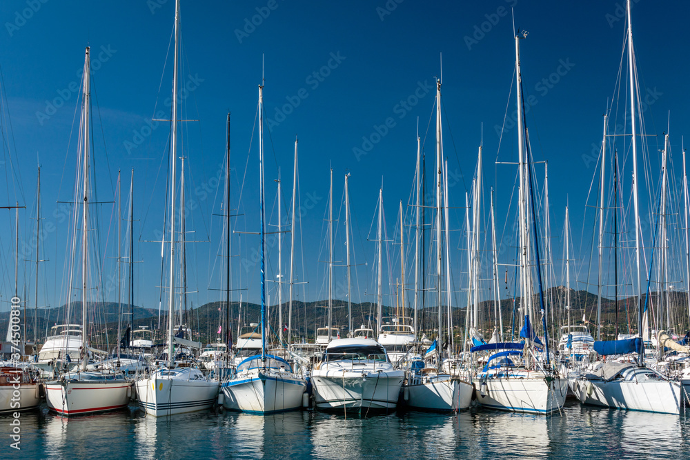 row of sailboats moored in the Saint Tropez marina on a sunny day