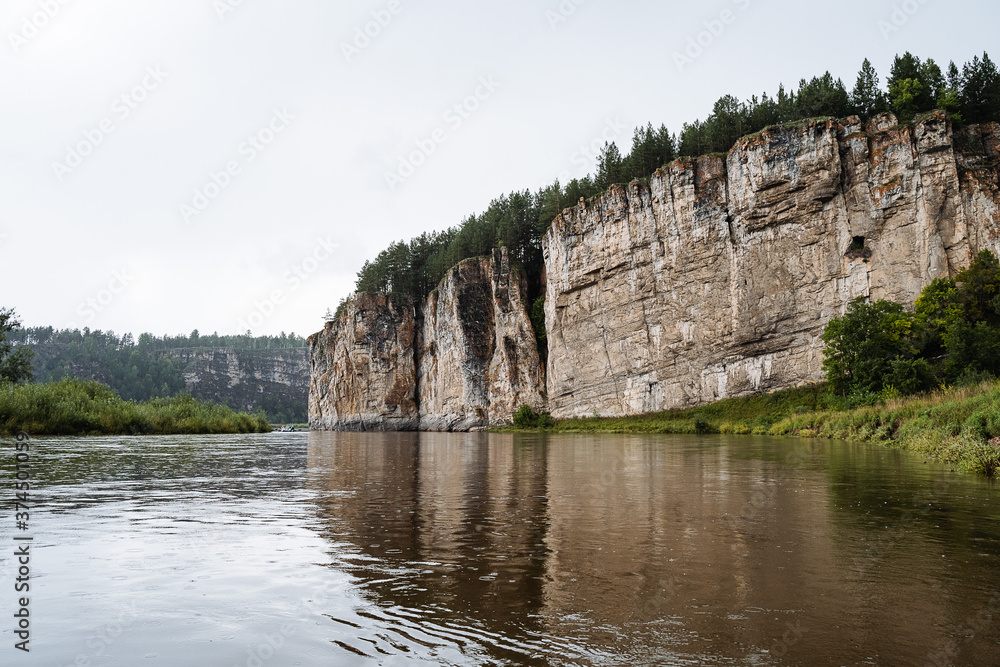 rock mass, river flows at the foot of the rocky mountains, white stone rocks, nature of Russia, southern Urals, Yuryuzan river, travel idea