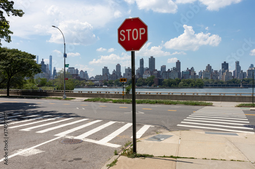 Stop Sign on the East River Riverfront of Astoria Queens New York with the Roosevelt Island and Manhattan Skyline during Summer