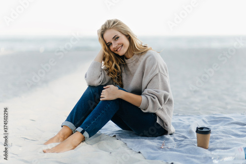 Winsome caucasian girl chilling at autumn beach Fototapeta