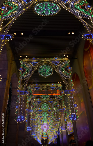 outdoor street festive christmas lights tunnel arch at night in milan, italy, europe