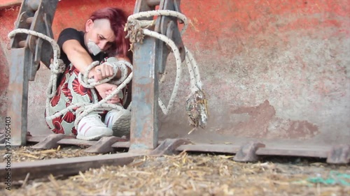 Wallpaper Mural woman kidnapped and raped bound with a rope and gagged with duct tape in a bucket of excavator who tries to break free but can not. Torontodigital.ca