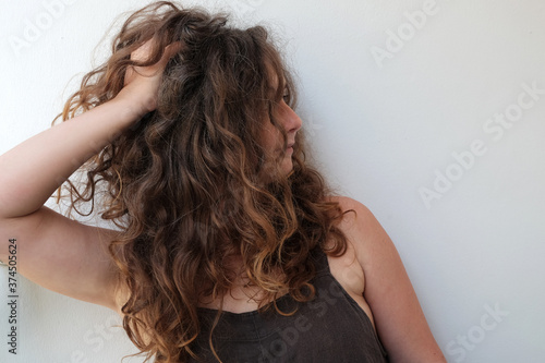portrait of a young woman posing over the wall long hairs