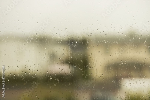 Close up view of raindrops running on window glass. Beautiful nature backgrounds.