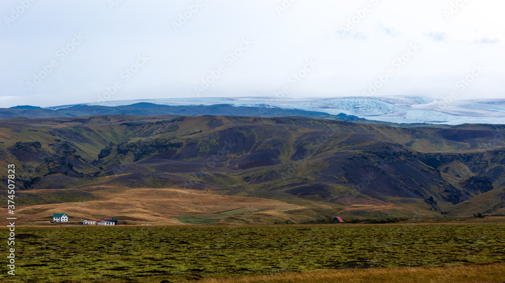 Naklejka premium Landscape of glacier of Jökulsárlónwith a farm in the foreground . SuðUrlandsvegur, Kirkjubæjarklaustur in Skaftárhreppur, at South region (ICELAND)