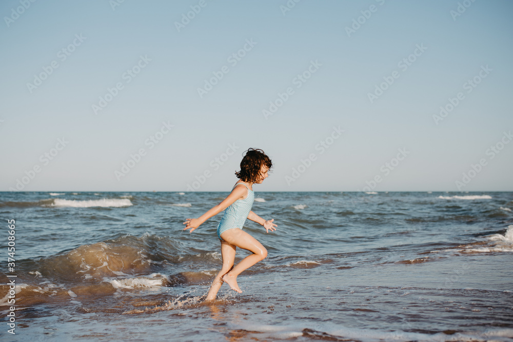 happy kids playing on beach in the day time