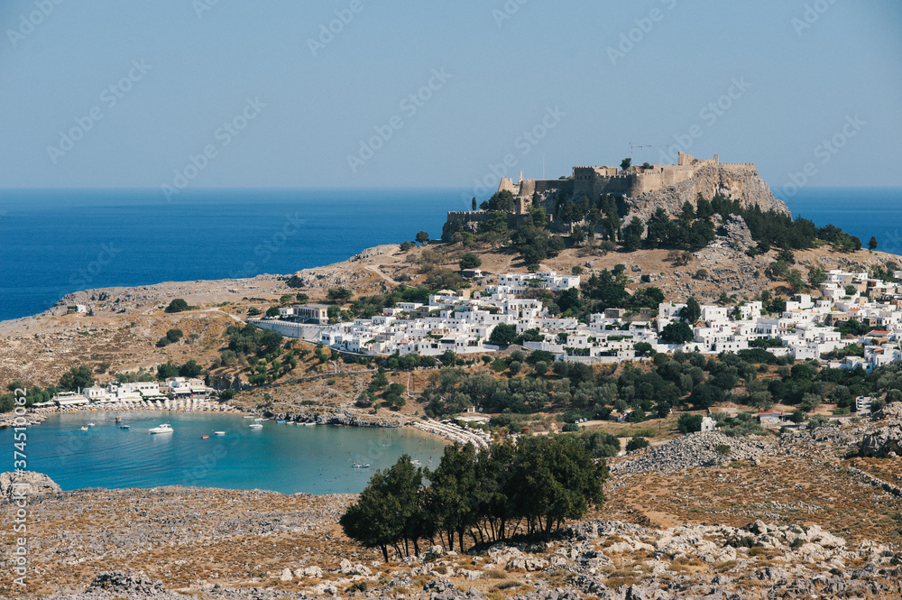 view of the coast of the sea with an old greek city