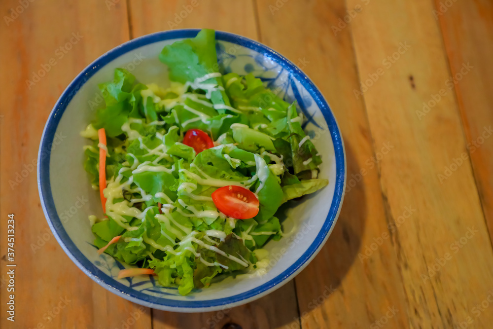 Salad on a wooden table dish Salad on a wooden table dish