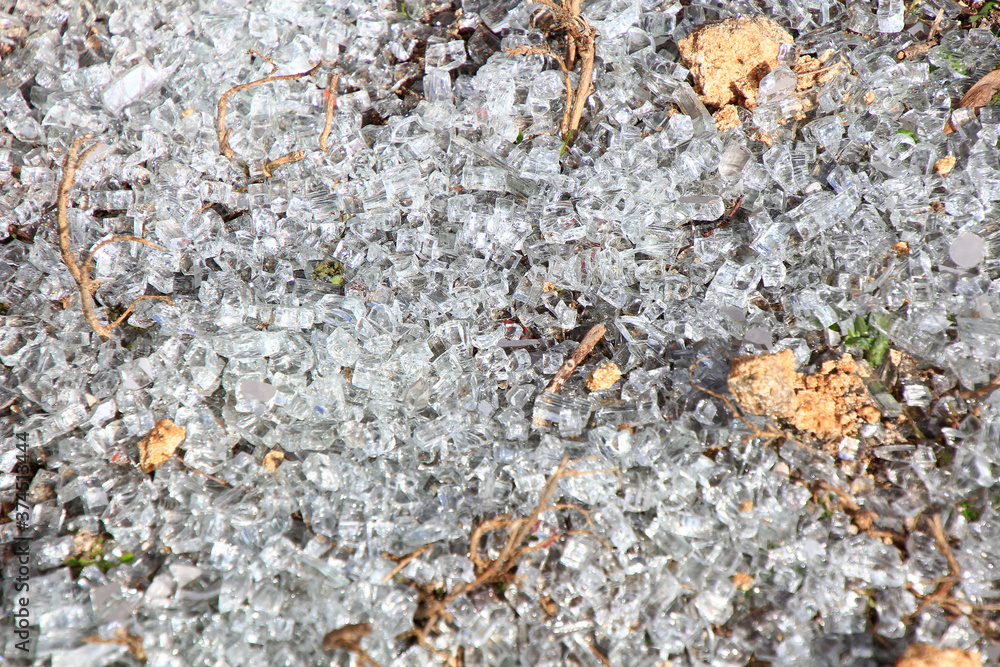 background with small pieces of broken glass covering the ground background with small pieces of broken glass covering the ground