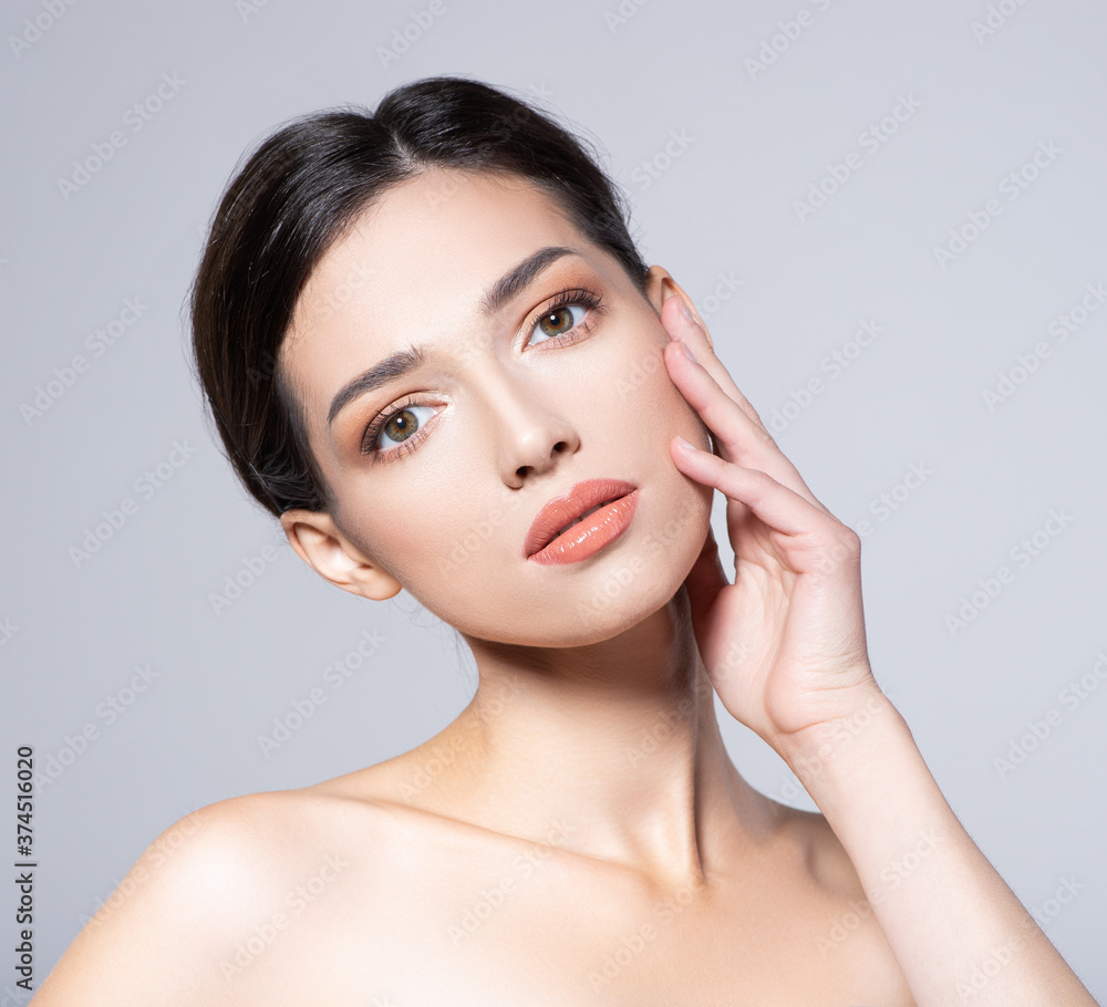Portrait of beautiful brunette woman with clean skin of face  - isolated on white. Photo of an Young girl with light natural eye makeup. Beauty face of young woman with healthy fresh skin.