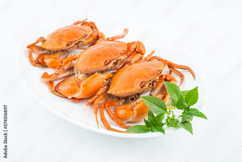 A dish of delicious steamed red sturgeon crab on white background A dish of delicious steamed red sturgeon crab on white background
