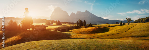 Wonderful Landscape with colorful sky. Seiser Alm (Alpe di Siusi) with Langkofel mountain at sunrise, Italy. Dolomites, Trentino Alto Adige, South Tyrol, Italy, Europe. Popular travel destination.
