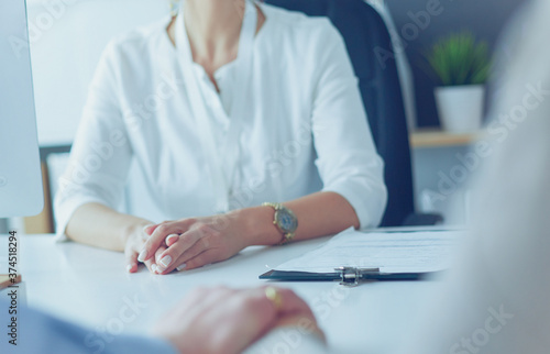 Couple talking to medical specialist, sitting at doctor's office photo