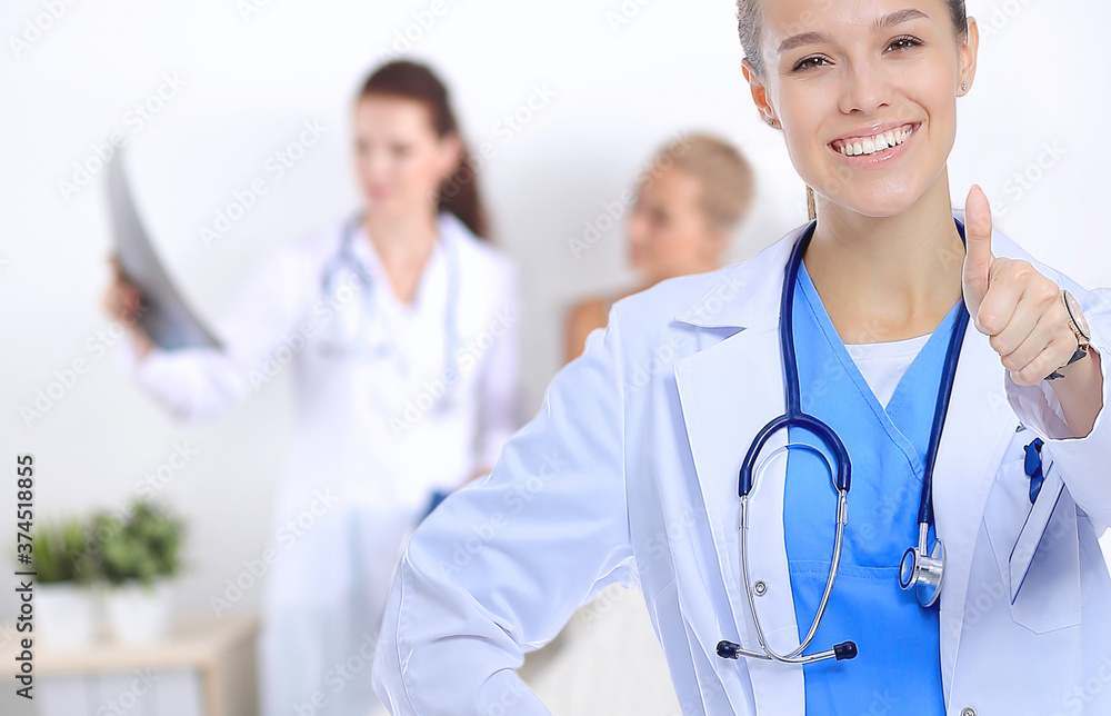 Smiling female doctor with a folder in uniform standing at hospital Smiling female doctor with a folder in uniform standing at hospital