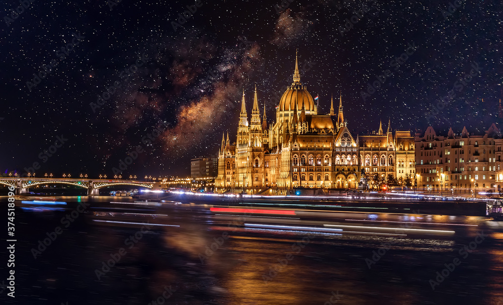 Gorgeous cityscape image of Budapest at night. view on Budapest city with starry sky. Majestic building of Hungarian parliament with night lighting. long exposure shot. Creative image for desing