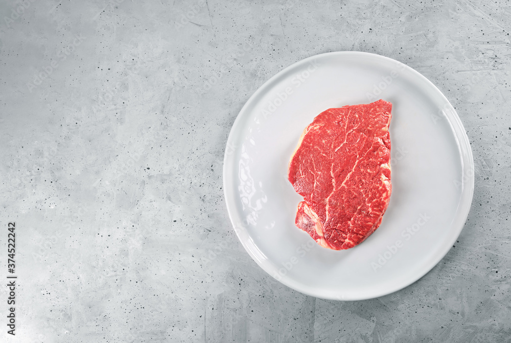 Beef meat on a white plate, top view Beef meat on a white plate, top view