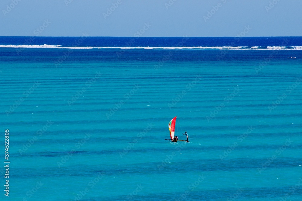 Fisherman boat sailing in the amazing blue sea water of Salary bay in the southwest of Madagascar 