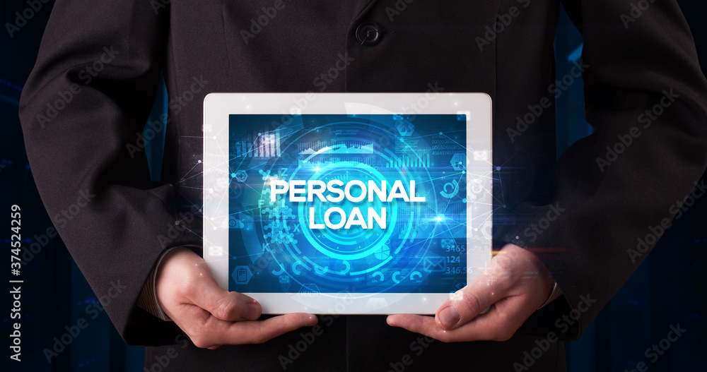 Young business person working on tablet and shows the inscription: PERSONAL LOAN, business concept Young business person working on tablet and shows the inscription: PERSONAL LOAN, business concept