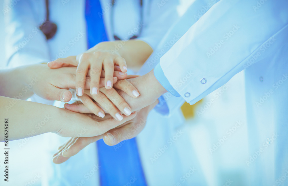 Group of doctors putting their hands together. Close-up Group of doctors putting their hands together. Close-up