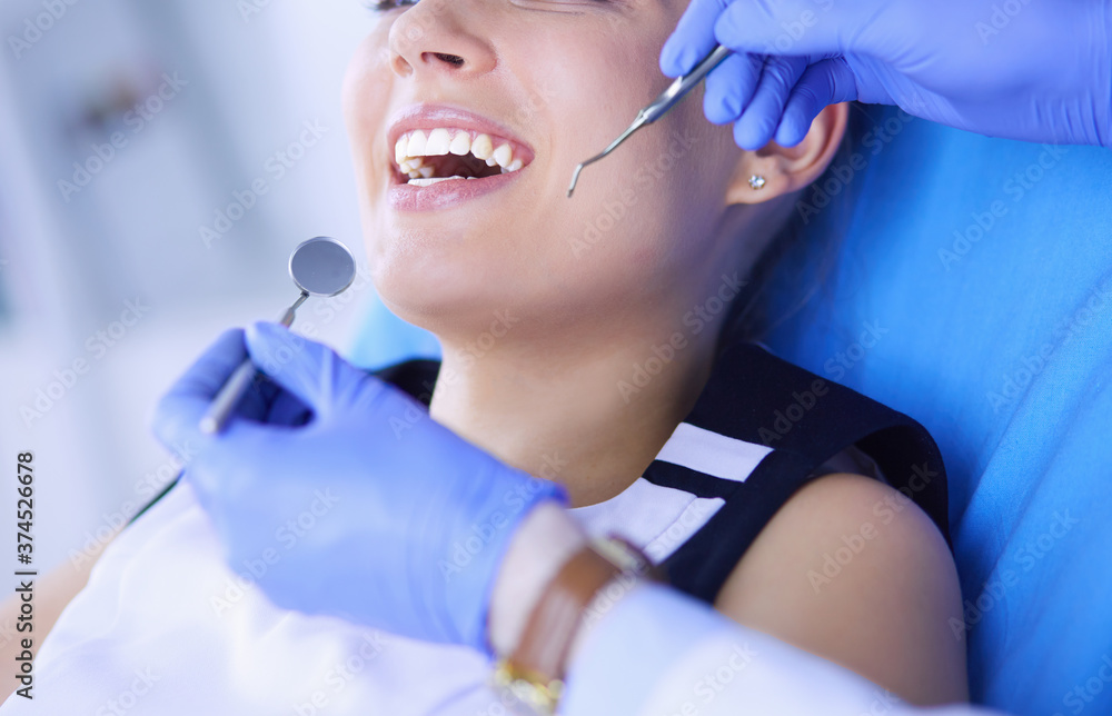 Young Female patient with open mouth examining dental inspection at dentist office. Young Female patient with open mouth examining dental inspection at dentist office.