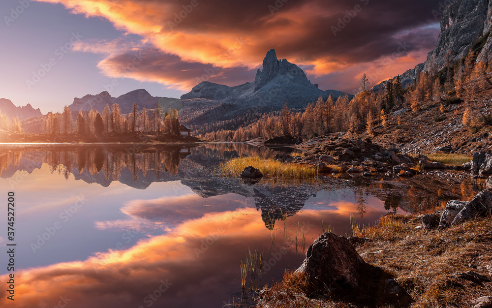 Fantastic colorful scenery in mountains during sunset. Fabulous landscape over calm mountain lake Federa in the summer morning, picture of Wild area. Stunning Natural Background. Creative image