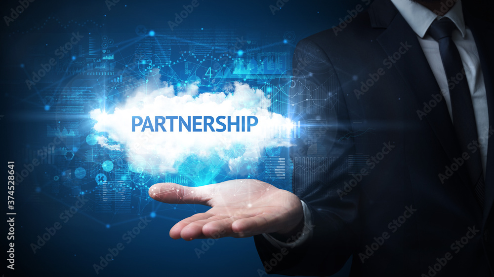 Hand of Businessman holding PARTNERSHIP inscription, successful business concept Hand of Businessman holding PARTNERSHIP inscription, successful business concept