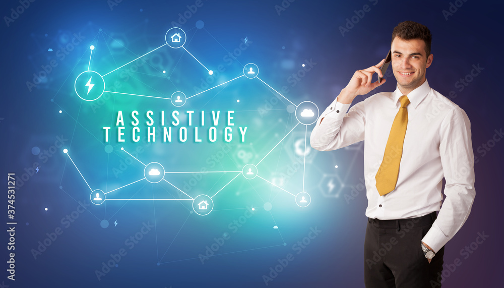 Businessman in front of cloud service icons with ASSISTIVE TECHNOLOGY inscription, modern technology concept Businessman in front of cloud service icons with ASSISTIVE TECHNOLOGY inscription, modern technology concept