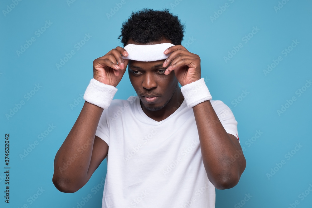 African young sportman being tired after exercise. African young sportman being tired after exercise.