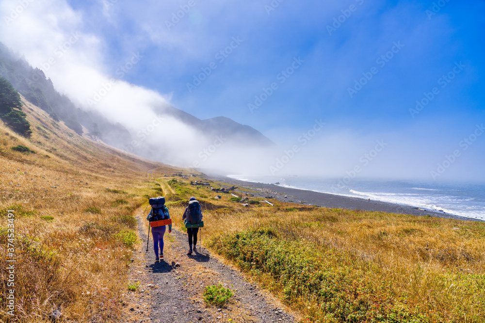 backpackers, trail, ocean, path, clouds, mountains, hills