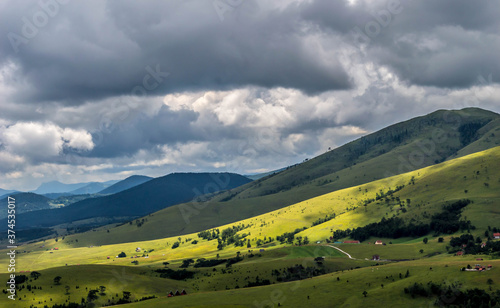 The landscape of Zlatibor Mountain in Serbia. Green meadows and hills under the blue sky with clouds in the summertime