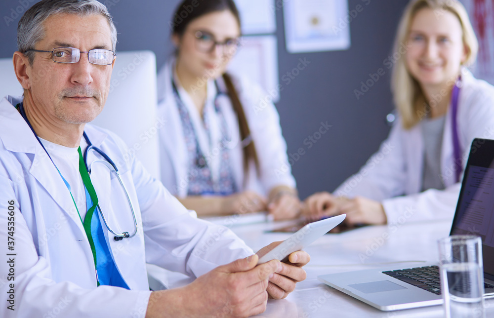 Doctor and patient discussing something while sitting at the table . Medicine and health care concept