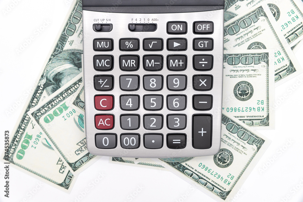 Calculator and dollars isolated on a white background Calculator and dollars isolated on a white background