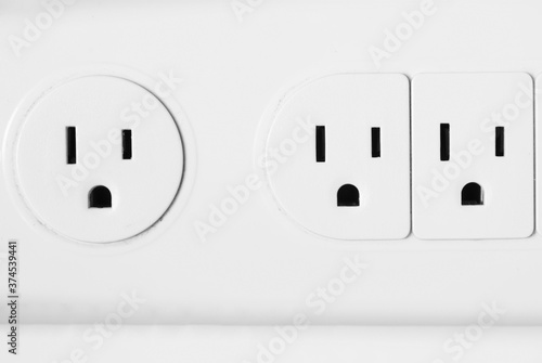 Original photograph of the outlets in a power strip appearing to be making shocked faces like Pareidolia photo