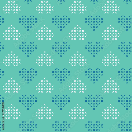 Vector cross stitch hearts on green seamless pattern print background.
